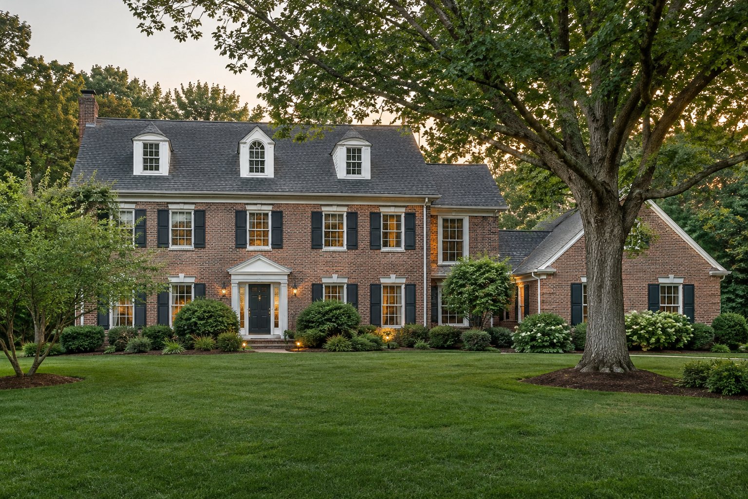 A Maryland brick colonial home with mature trees in soft evening light, illustrative